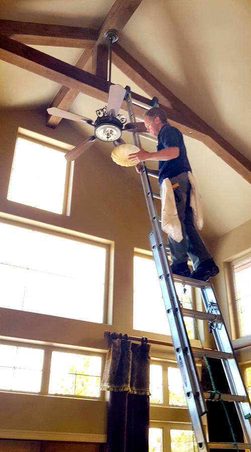 Photo: dusting high objects by PEAK Window Cleaning.