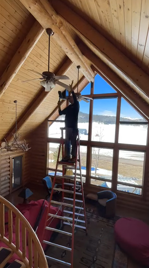 Photo: dusting high objects by PEAK Window Cleaning.